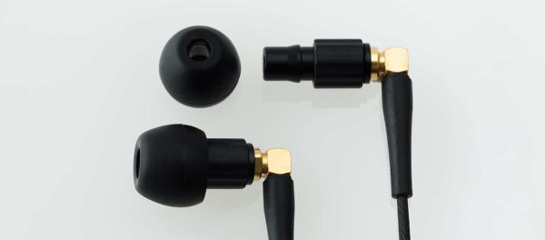 A pair of Final Audio - F4100 - stereo earphones with black and gold design.