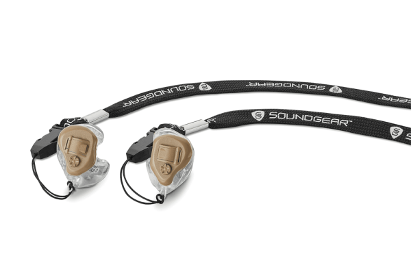 A close-up of the volume control buttons on tan Soundgear Silver model hearing aids with cords