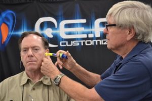 Garry Gordon fits a customer with Phantom custom earplugs