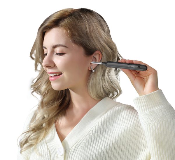 Woman shown inserting an EAR/BeBird X1 otoscope in her ear canal.