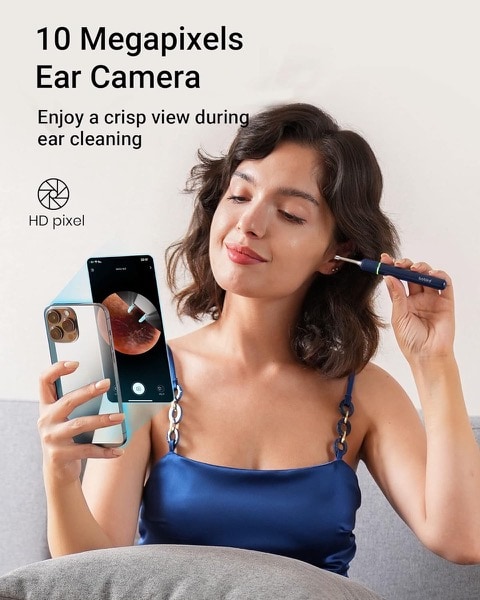 Woman using digital otoscope to remove ear wax from ears.