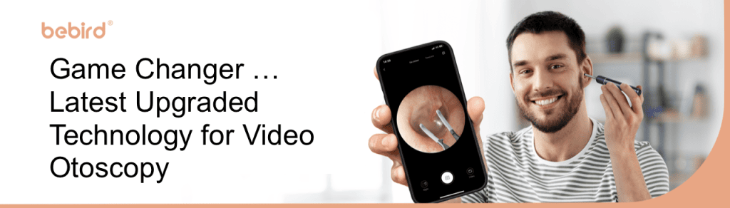 Man holding a digital Note 5 otoscope in one hand and a smartphone in the other that shows his ear canal. Words on the left "Game Changer...Latest Upgraded Technology for Video Otoscopy"