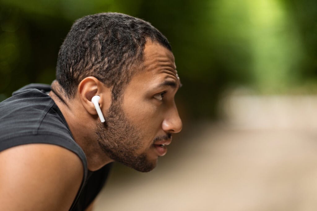 Man wearing Bluetooth Earbuds